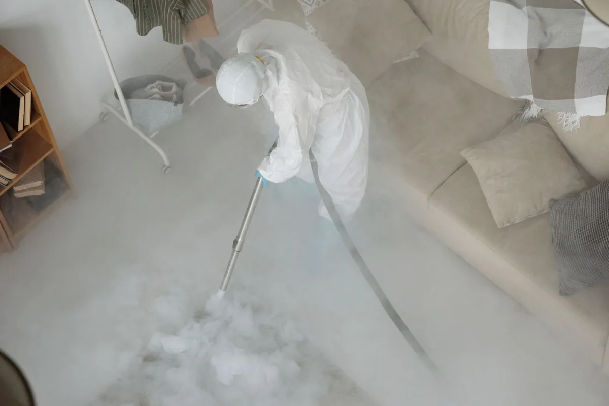 Biohazard cleanup technician in protective equipment, Baird, TX